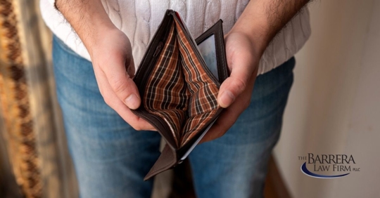 Man opening a wallet that is empty