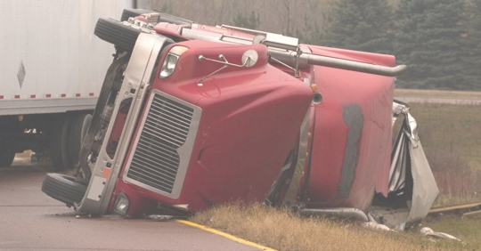 Large red truck overturned