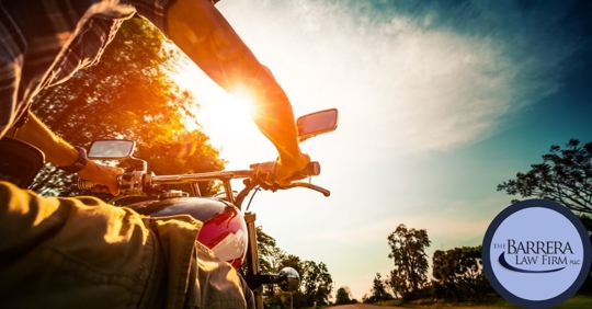 Motorcycle rider riding into the sunlight