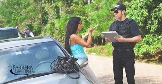 Police questioning woman outside of the car.
