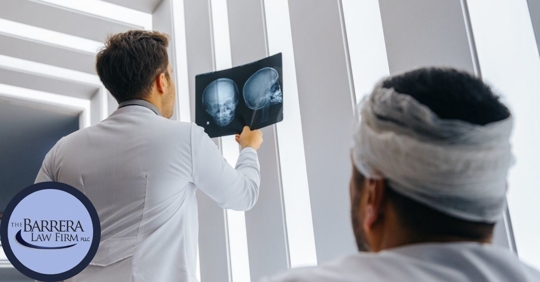 Man with a bandage wrapped around his head with his doctor looking at skull x-ray