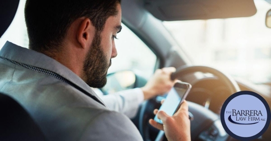 Image of man texting while driving
