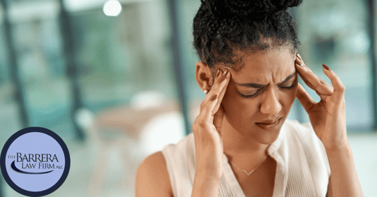 Latina woman holding her fingers to the temple of her head.
